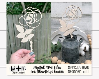 May include: A digital SVG file for a rose design, ideal for cutting on a Glowforge laser. The design is simple and easy to cut, making it a great project for beginners. The image shows the rose cut out of wood and displayed in a metal milk jug.