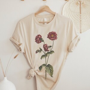 A short sleeve crew neck t shirt with a vintage floral bouquet design. The shirt used is the Bella Canvas 3001 unisex jersey tee and is very soft and high quality. Available in several different colors.