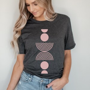 A short sleeve crew neck t shirt with a light pink boho abstract design on the front. The shirt is the Bella Canvas 3001 unisex jersey tee. Very soft and high quality. Available in several different colors.