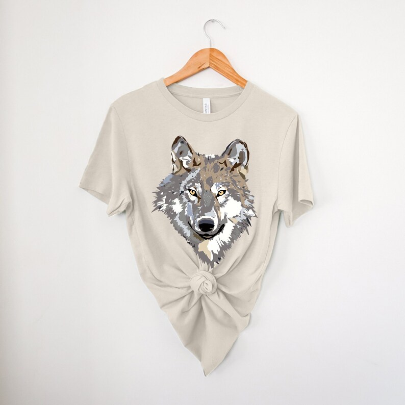 A short sleeve crew neck tee with an abstract wolf head design on the front. The shirt is the Bella and Canvas 3001 unisex jersey tee. Very soft and high quality shirt. Available in many colors and sizes.