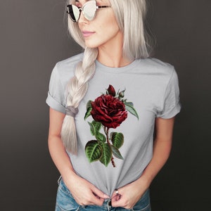 May include: A gray t-shirt with a red rose graphic print.