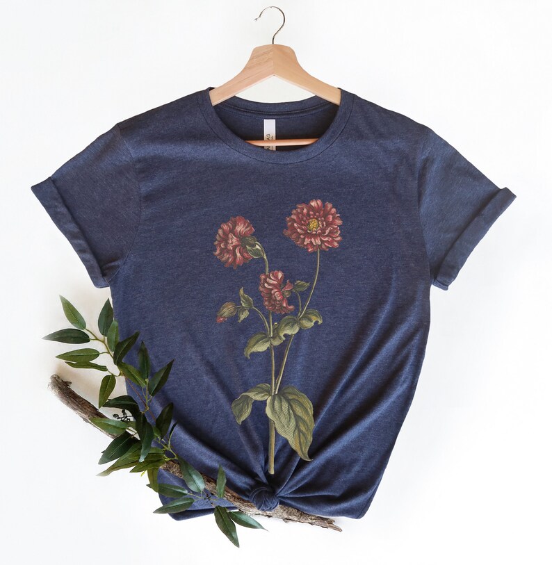 May include: A navy blue t-shirt with a vintage floral print featuring three red flowers with green leaves.