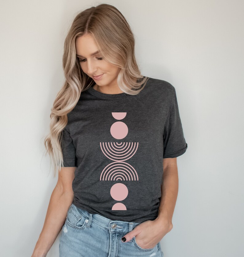 A short sleeve crew neck t shirt with a light pink boho abstract design on the front. The shirt is the Bella Canvas 3001 unisex jersey tee. Very soft and high quality. Available in several different colors.