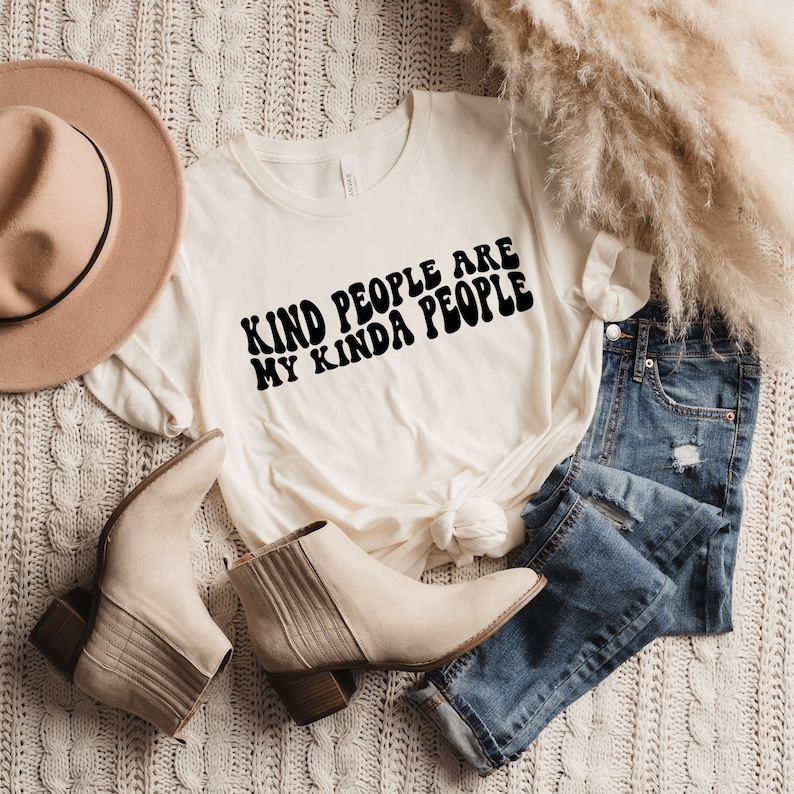 A short sleeve crew neck t shirt that says, "KIND PEOPLE ARE MY KINDA PEOPLE" in a black retro font. The shirt is the Bella and Canvas 3001 unisex jersey tee. Very soft and high quality. Available in many sizes and colors.