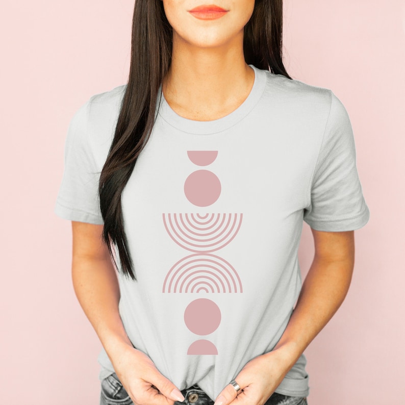 A short sleeve crew neck t shirt with a light pink boho abstract design on the front. The shirt is the Bella Canvas 3001 unisex jersey tee. Very soft and high quality. Available in several different colors.