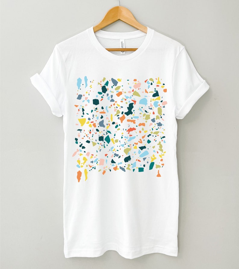 A short sleeve crew neck tee with a colorful abstract speckles design. The shirt is Bella Canvas 3001 unisex jersey tee. Many colors and sizes available. Very soft and high quality! Can be worn with sleeves rolled up or down.