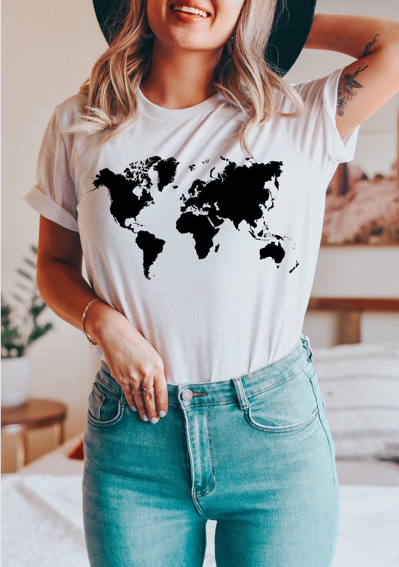 May include: A white t-shirt with a black outline of the world map printed on the front.