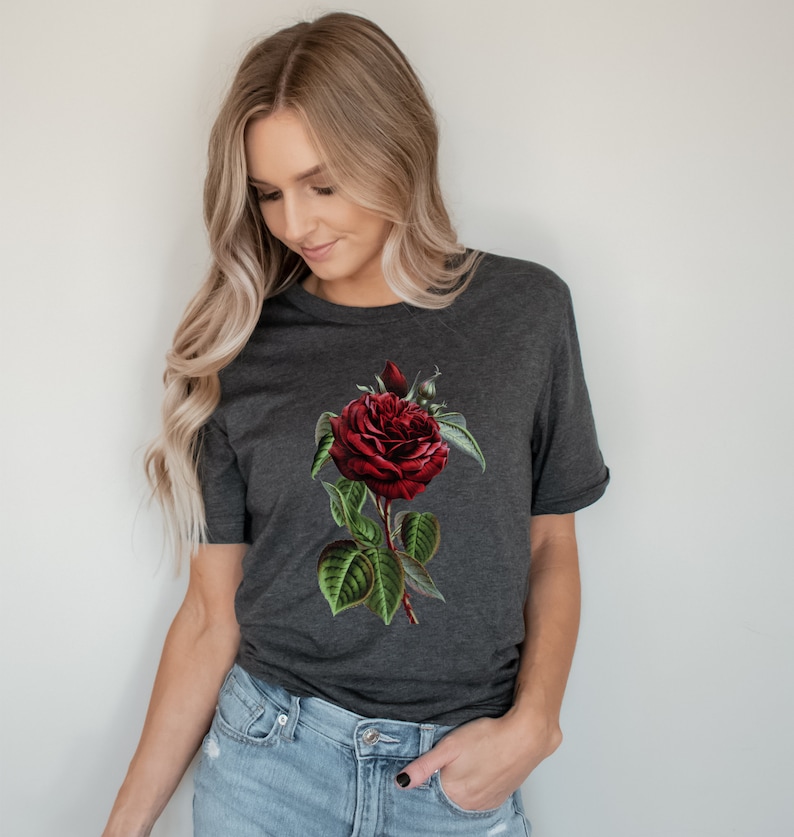 May include: A dark grey t-shirt with a red rose graphic. The rose has green leaves and a stem.