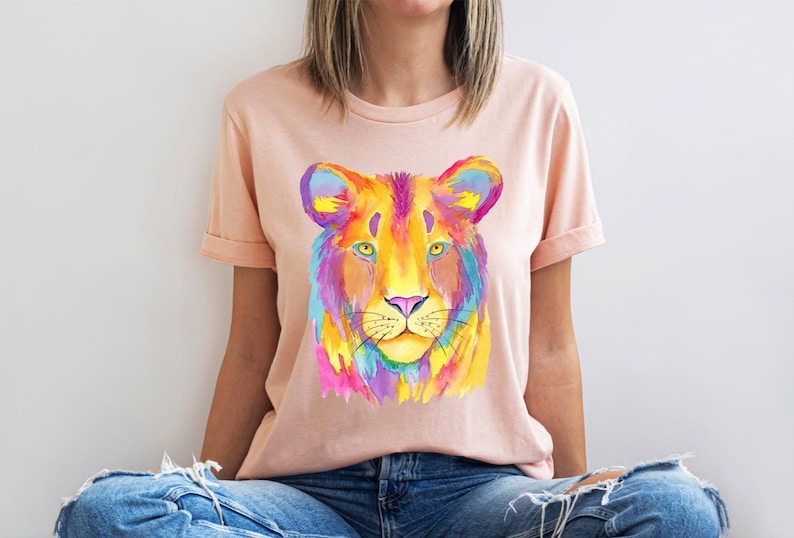 A short sleeve crew neck t shirt with a colorful neon lion graphic. The shirt is the Bella Canvas 3001 unisex graphic tee. Very soft and high quality. Available in several colors.