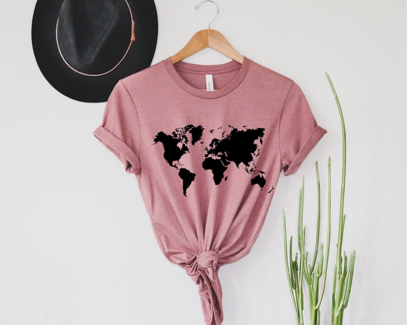 A short sleeve t shirt with a black world map graphic on the front. The shirt is the Bella and Canvas 3001 unisex jersey tee. Very soft and high quality. The color pictured is heather mauve. Available in many colors and sizes.