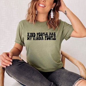 May include: A green t-shirt with the text "Kind people are my kinda people" in black retro font.