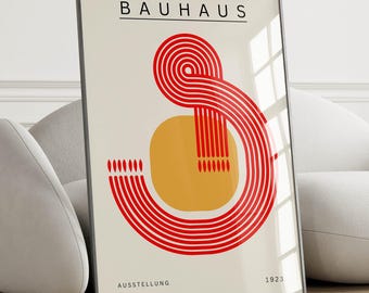 May include: A framed print with a red and yellow geometric design. The print has the text "BAUHAUS" and "AUSSTELLUNG 1923" at the top and bottom.