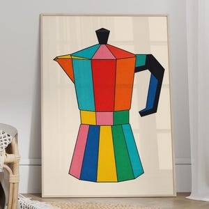 May include: A framed wall art print featuring a stylised, geometric illustration of a moka pot coffee maker. The design uses vibrant, solid blocks of red, orange, teal, yellow, green, and blue, set against a light cream-coloured background.