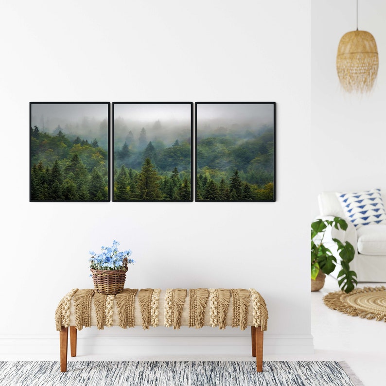 May include: A set of three framed prints depicting a misty forest scene with lush green trees. The prints are arranged in a horizontal row and feature a panoramic view of the forest.