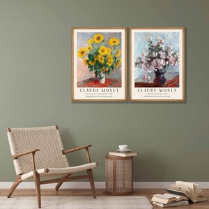 May include: Two framed art prints of paintings by Claude Monet. The left print features a bouquet of sunflowers in a vase on a table with a red tablecloth. The right print features a bouquet of white flowers in a vase on a table with a dark brown tablecloth. Both prints include the title of the painting and the year it was created, as well as the Metropolitan Museum of Art.