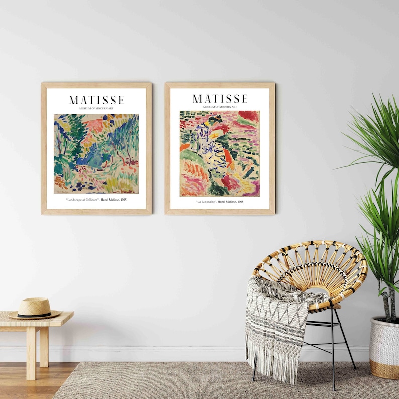 May include: Two framed art prints of paintings by Henri Matisse. The prints are in wooden frames with white mats. The left print is titled "Landscape at Collioure" and the right print is titled "La Japonaise".
