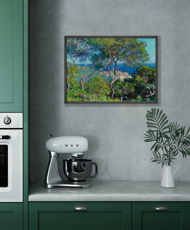 May include: A framed painting of a seascape with a view of a town nestled among trees. The painting is in a dark wood frame and is hanging on a gray wall.