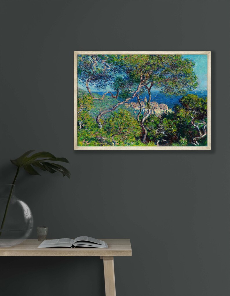 May include: A painting of a coastal scene with a view of a town from a hillside. The painting is done in a style reminiscent of Impressionism, with visible brushstrokes and a focus on light and color. The scene is dominated by a bright blue sky and a turquoise sea, with lush green trees in the foreground.