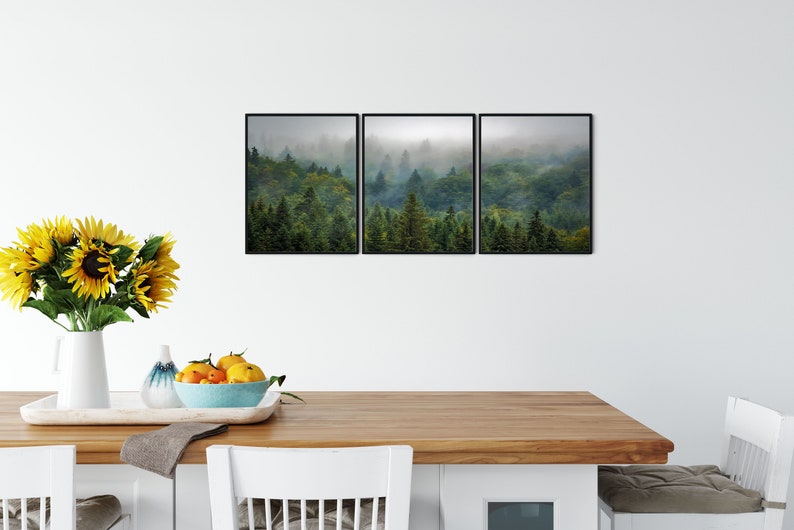 May include: A set of three framed prints depicting a misty forest scene with lush green trees. The prints are arranged in a horizontal row and feature a muted color palette.