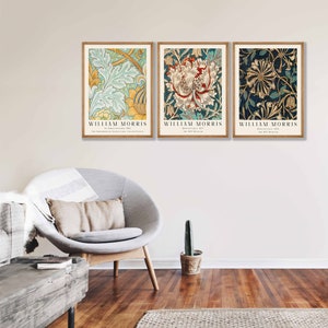 May include: Three framed prints of floral patterns by William Morris. The prints feature a blue and green floral pattern, a red and white floral pattern, and a yellow and gold floral pattern.
