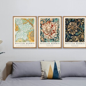 May include: Three framed prints of floral patterns by William Morris. The prints feature intricate designs in shades of green, blue, yellow, and red. Each print includes the artist's name and the title of the work.