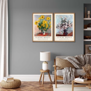 May include: Two framed art prints of flower paintings by Claude Monet. The first print shows a bouquet of sunflowers in a vase on a table. The second print shows a bouquet of white flowers in a vase on a table. Both prints have the artist's name and the title of the painting.
