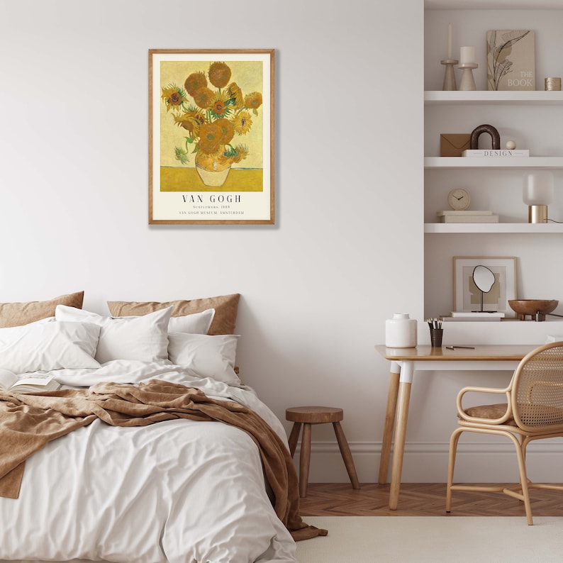May include: A framed print of a painting by Vincent van Gogh featuring a vase of sunflowers. The painting is titled "Sunflowers" and is dated August 1888. The print is in a wooden frame and has a white background.