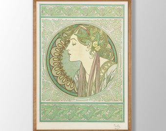 May include: A framed print of a woman's profile in a green and gold Art Nouveau style. The woman has long, flowing hair and is wearing a white dress. The print is surrounded by a decorative border of leaves and flowers.