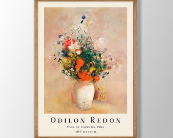 May include: A framed poster of a painting by Odilon Redon titled "Vase of Flowers, 1906". The painting depicts a white vase filled with a colorful bouquet of flowers, including red poppies, white daisies, and blue cornflowers. The background is a soft, peachy color.