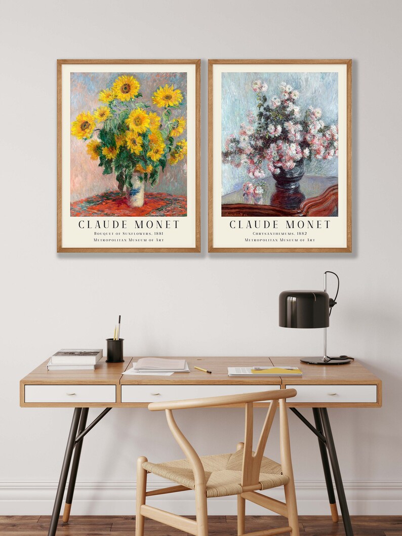 May include: Two framed art prints of paintings by Claude Monet. The left print shows a bouquet of sunflowers in a vase on a table with a red tablecloth. The right print shows a bouquet of pink chrysanthemums in a vase on a table with a brown tablecloth. Both prints include the title of the painting and the museum where it is located.