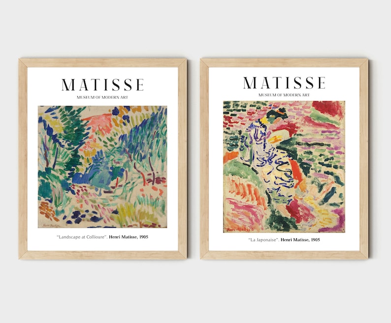 May include: Two framed art prints of paintings by Henri Matisse. The first print is titled "Landscape at Collioure" and depicts a colorful landscape with trees and hills. The second print is titled "La Japonaise" and features a woman in a colorful dress standing in a landscape.