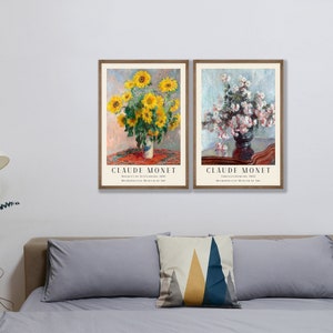 May include: Two framed art prints of flower arrangements by Claude Monet. The left print features a bouquet of yellow sunflowers in a vase on a red tablecloth. The right print shows a bouquet of white flowers in a dark vase on a wooden table. Both prints have the artist's name and the title of the artwork.