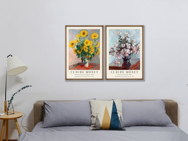 May include: Two framed art prints of flower arrangements by Claude Monet. The left print features a bouquet of yellow sunflowers in a vase on a red tablecloth. The right print shows a bouquet of white flowers in a dark vase on a wooden table. Both prints have the artist's name and the title of the artwork.