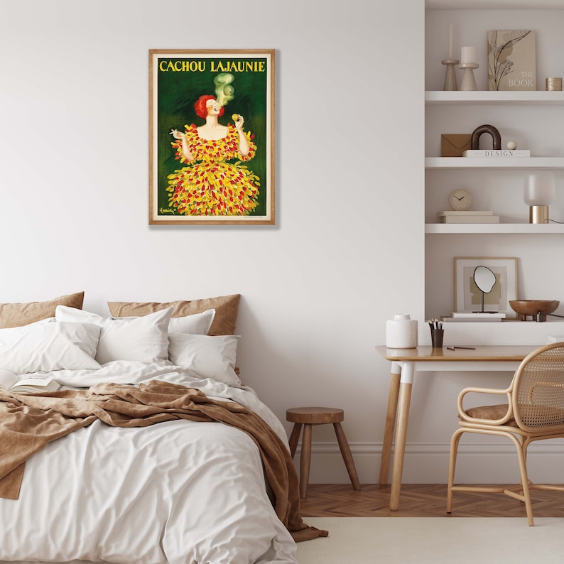 May include: A vintage poster advertising Cachou Lajaunie, a brand of cough drops. The poster features a woman in a yellow and red dress with a green background. The text "Cachou Lajaunie" is printed in black at the top of the poster.