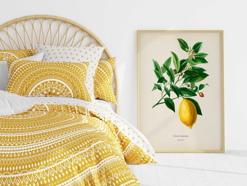 May include: A yellow and white patterned duvet cover with a yellow and white patterned pillow on a bed with a wicker headboard. A framed botanical print of a lemon branch with the text "Citrus Limonum" is on the wall.