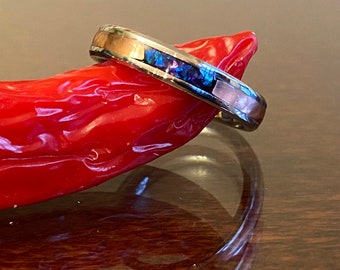 May include: A silver band ring with a thin inlay of abalone shell and a copper band.