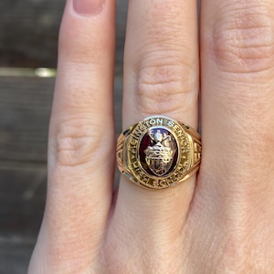 May include: A gold class ring with a red stone and the inscription "Washington Senior High School".