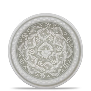 May include: A round, ceramic plate with a white floral design on a gray background. The plate has a raised rim with a repeating pattern. The floral design includes stylized flowers and small, round accents. The plate is likely used for serving food or as a decorative item.