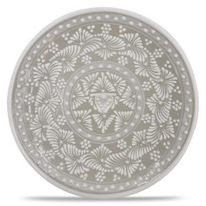 May include: A round, gray ceramic plate with a white, raised floral and leaf design. The plate has a wide, white rim and a detailed, symmetrical pattern in the center. The design includes stylized flowers, leaves, and small, round accents.