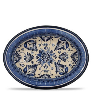 May include: Oval ceramic serving platter with a blue and white floral design. The platter has a cream-colored center with intricate blue floral patterns and a blue border. The rim is a darker blue with a thin white stripe.