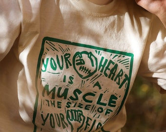 Your heart is a muscle the size of your fist/ ringspun cotton Unisex T-shirt.