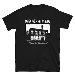 May include: Black t-shirt with white text that reads "Mischief Brew" and a graphic of a building with the text "Jobs in Steeltown".