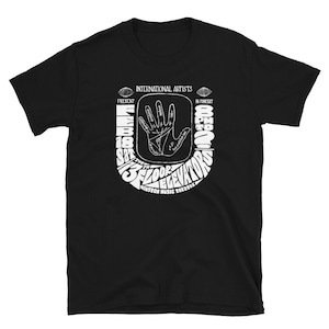 May include: Black t-shirt with a white graphic design featuring a hand with lines and the text "INTERNATIONAL ARTISTS PRESENT THE 13TH FLOOR ELEVATORS IN CONCERT SAT FEB 18 HOUSTON MUSIC THEATRE".