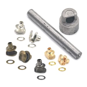 May include: A set of metal eyelets and a tool for installing them. The set includes eyelets in silver, gold, and black finishes, as well as a tool with a handle and a punch.
