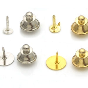 May include: Six metal tie tacks, three gold and three silver. Each tack has a round base with a pin on top and a decorative top with a round ball.
