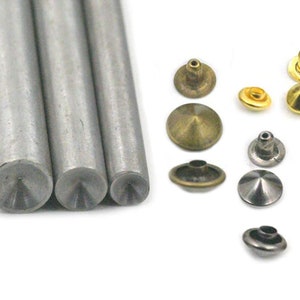 May include: Three metal tools for setting cone-shaped rivets. The tools are silver and have a pointed tip. There are nine cone-shaped rivets in various sizes and colors, including gold, silver, and black.