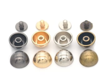 May include: A collection of four sets of metal dome rivets in various finishes: black, gold, silver, and antique brass. Each set includes a dome-shaped cap and a post for securing the rivet. Ideal for leathercraft and DIY projects.