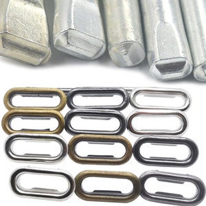 May include: Set of metal eyelets in silver, gold, and black. The eyelets are oval shaped and come in different sizes. There are also four metal tools for setting the eyelets.