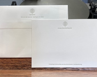 May include: A white envelope and a white note card with the Earthworks logo, which is a stylized tree inside a circle. The text on the envelope reads "EARTHWORKS 1612 K St. NW, Suite 904 Washington, DC 20006". The text on the note card reads "A note from Earthworks Protecting Communities and the Environment | Earthworks.org".