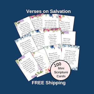 May include: A set of 100 mini scripture cards with watercolor floral designs. The cards feature verses on salvation from the Bible. The text on the cards is in black and white. The cards are printed on white cardstock and have a pink border. The cards are arranged in a grid pattern. The text "100 Mini Scripture Cards" is printed in pink on a white circle in the center of the image. The text "FREE Shipping" is printed in white on a pink background at the bottom of the image.